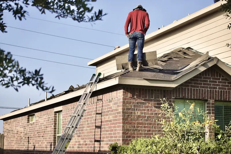 Professional roofer working on a residential roof in Norwood Park